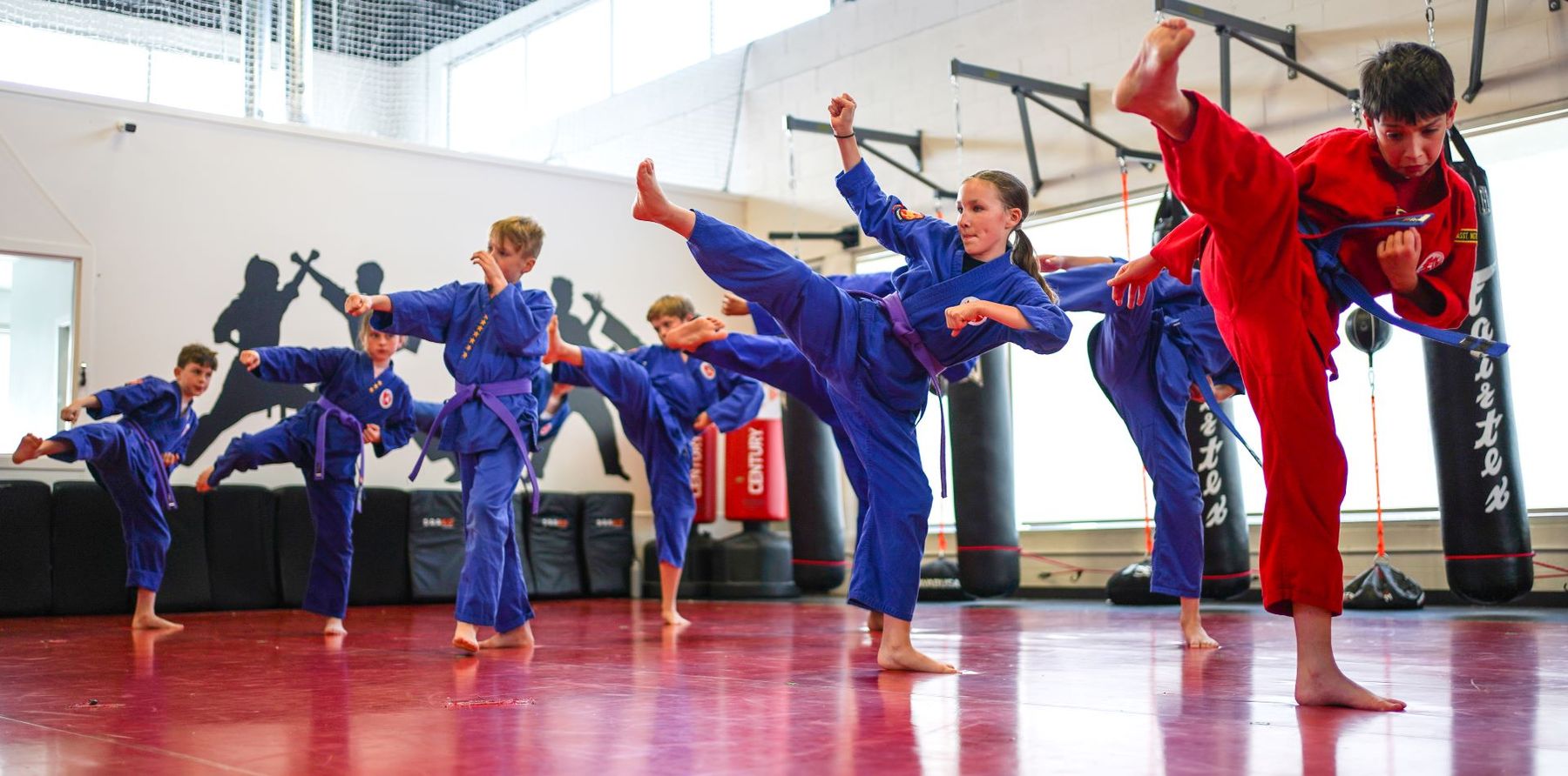 Students practising high kicks in class at Safeguard Martial Arts in Langley